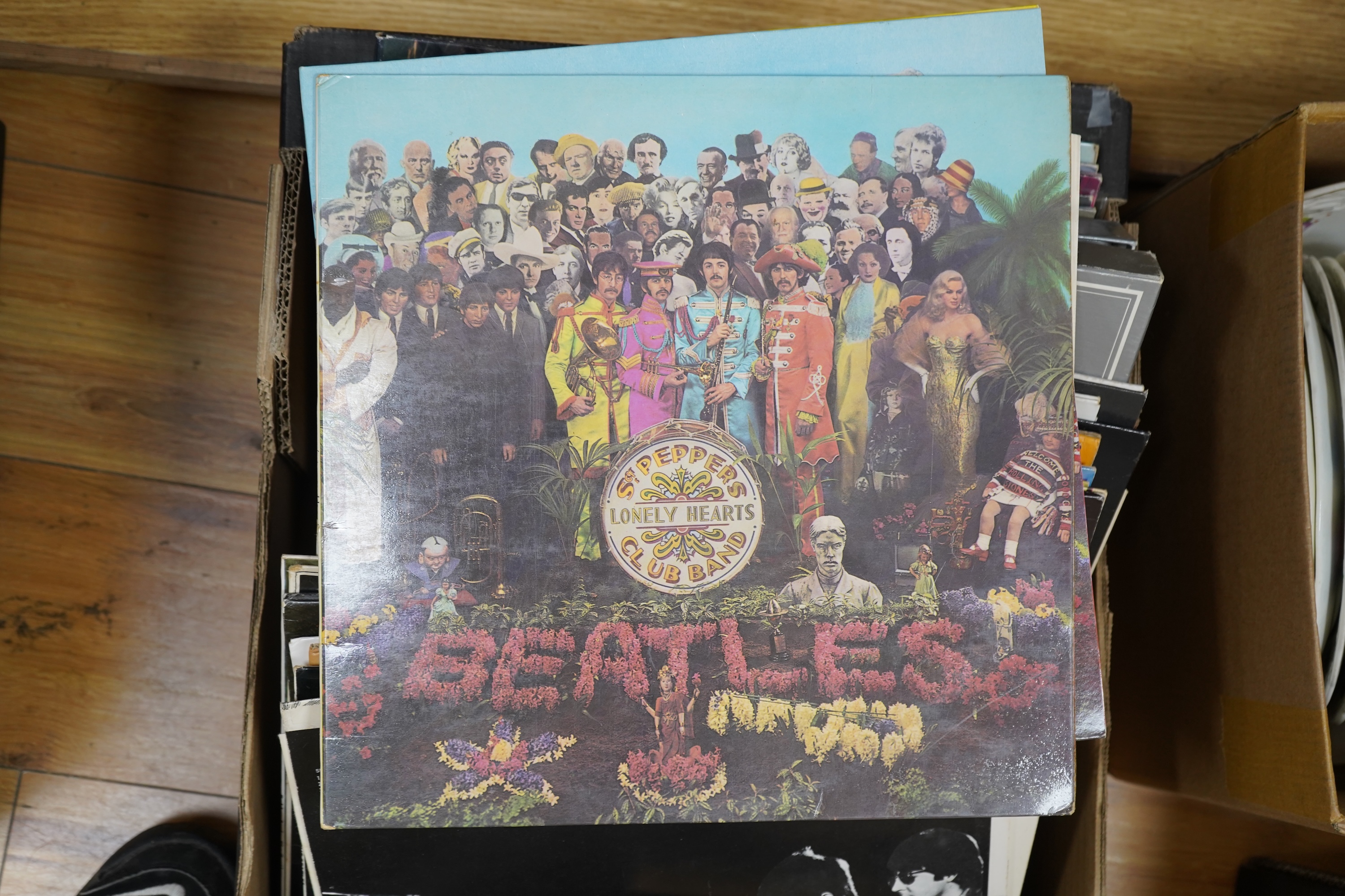 A collection of Beatles related LP's and singles, 36 LPs and a John Lennon box set, including; the ‘White Album’, a side loading issue, numbered 0111352, Revolver, Abbey Road, Sgt. Pepper, Let It Be, Beatles For Sale, Wi